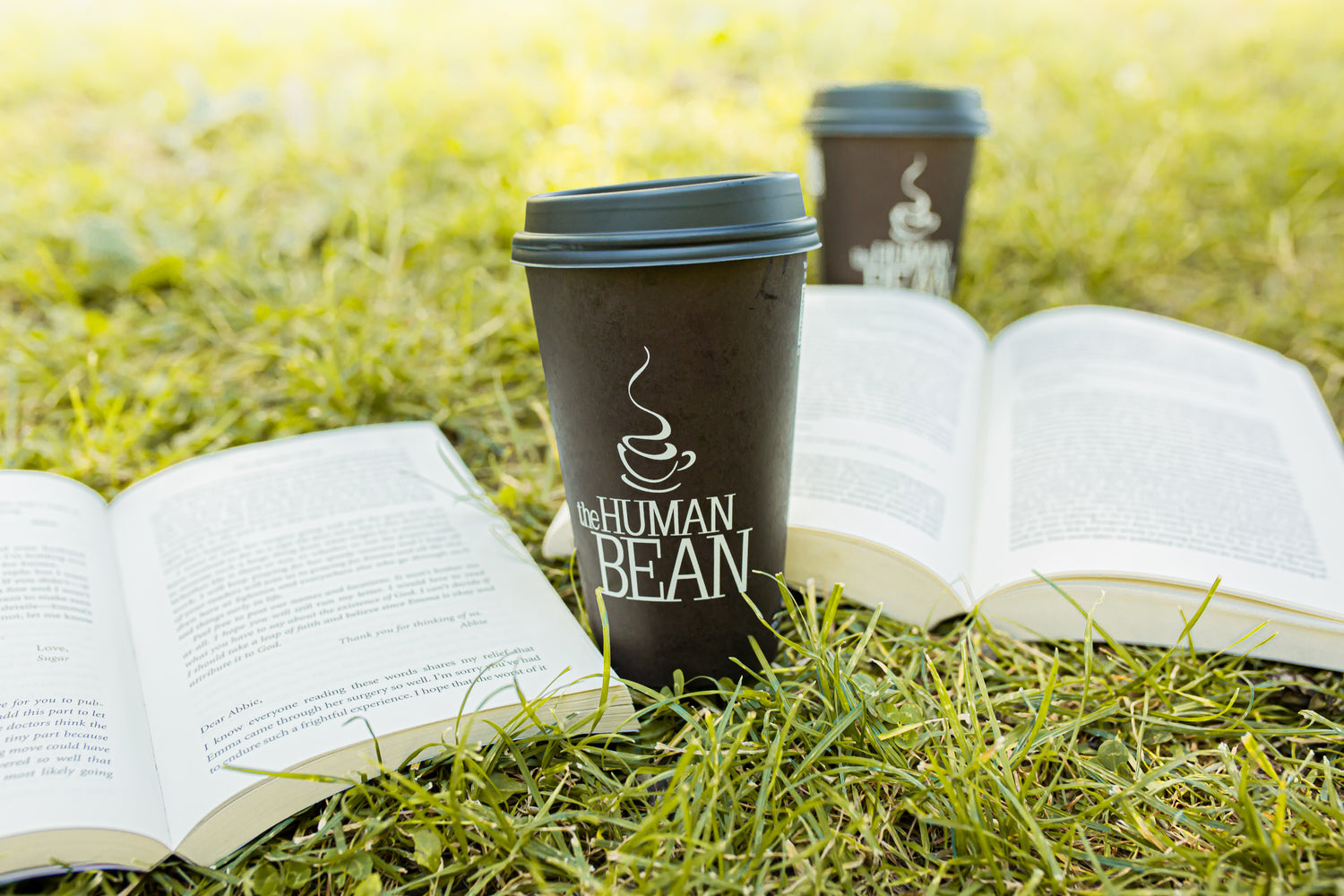 The Human Bean cup with books