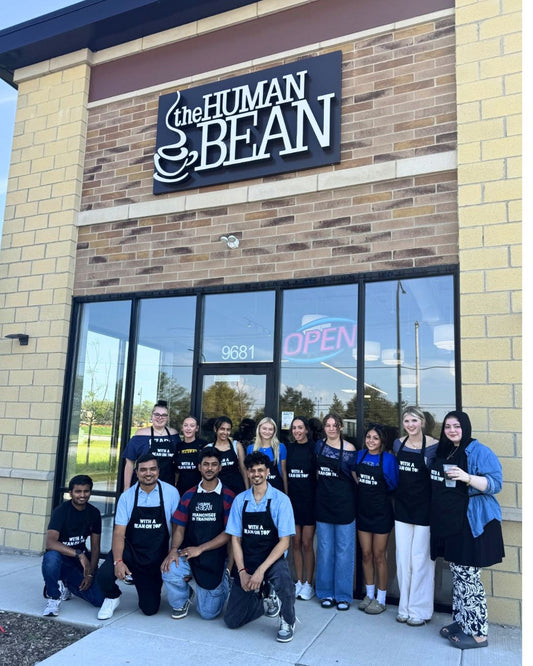 Owners Anand, Yogesh, and their staff pose in front of The Human Bean in Mokena, IL prior to their opening date of October 1, 2026.