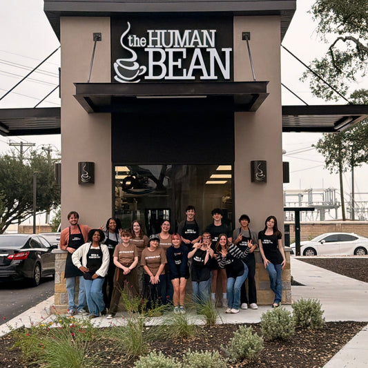 Baristas at The Human Bean Cedar Park, Texas pose in front of the new store.
