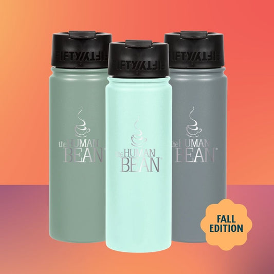 Three insulated water bottles from The Human Bean in sage green, mint green, and slate gray, arranged against a warm orange-to-pink gradient background with a yellow 'FALL EDITION' badge.