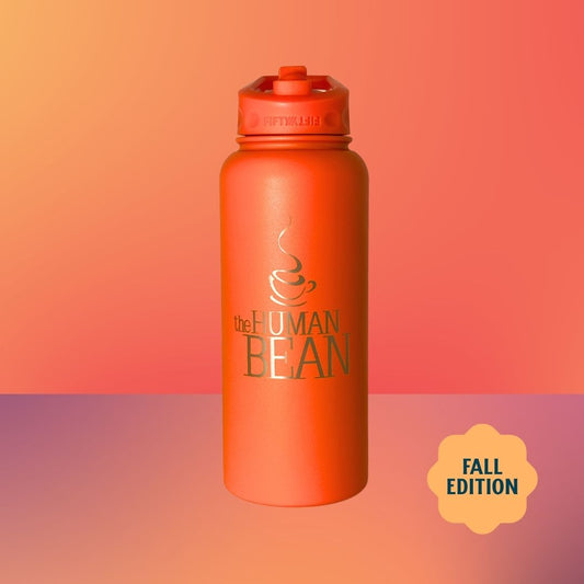 An orange insulated water bottle with a matching orange flip-top lid, featuring the text 'the HUMAN BEAN' and a coffee cup logo on the front. The bottle is centered against a warm orange-to-pink gradient background with a yellow 'FALL EDITION' badge in the lower right corner.