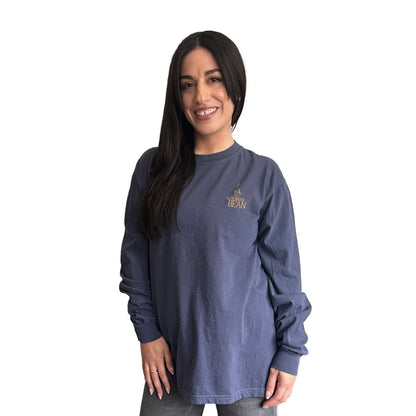 Woman wearing a blue long-sleeve shirt with The Human Bean logo on a white background.