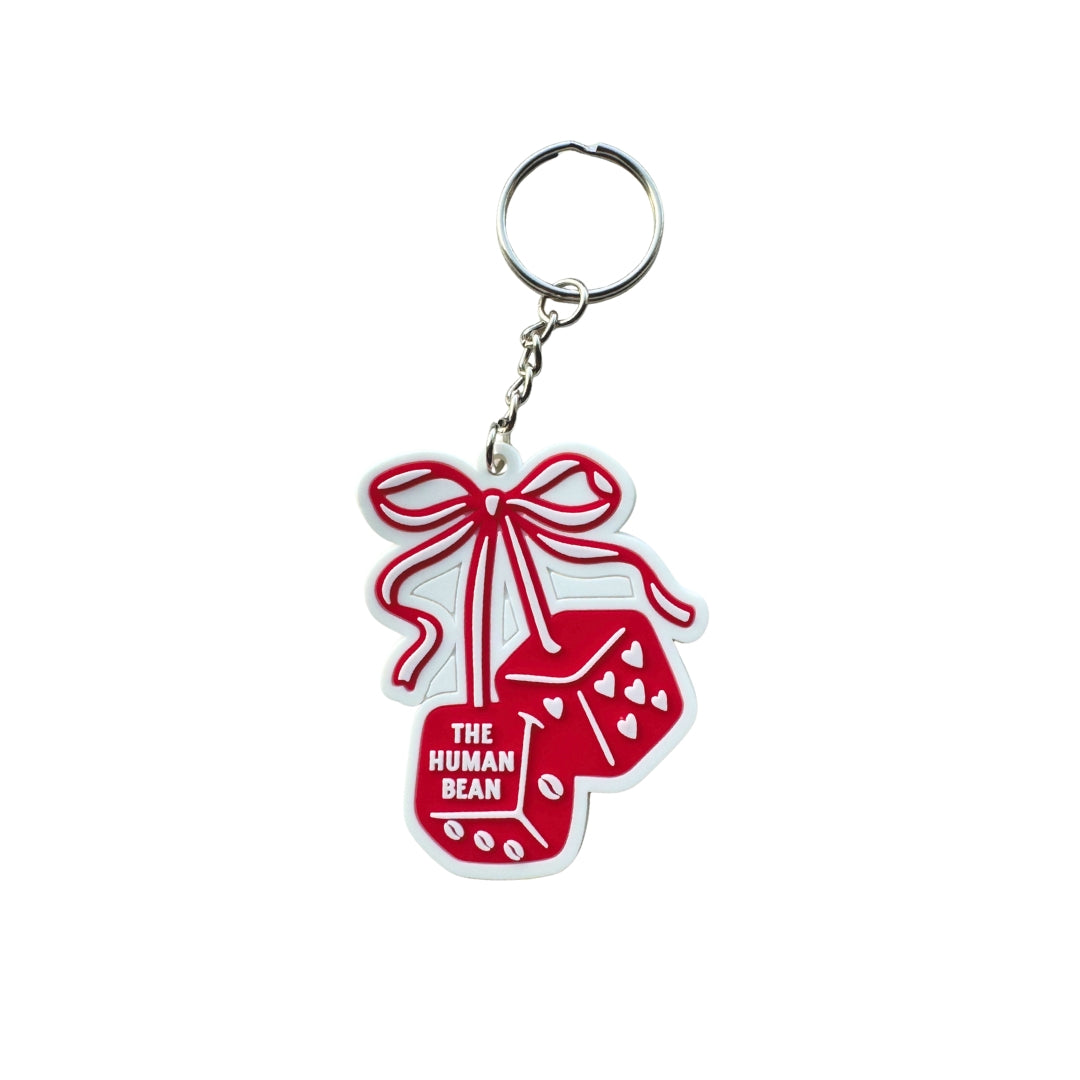 Red keychain with 'The Human Bean' logo on a white background