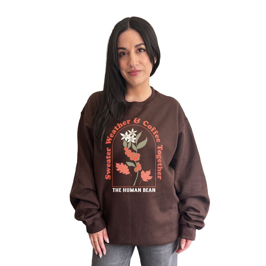 Woman wearing a brown sweatshirt with floral design and text on a white background