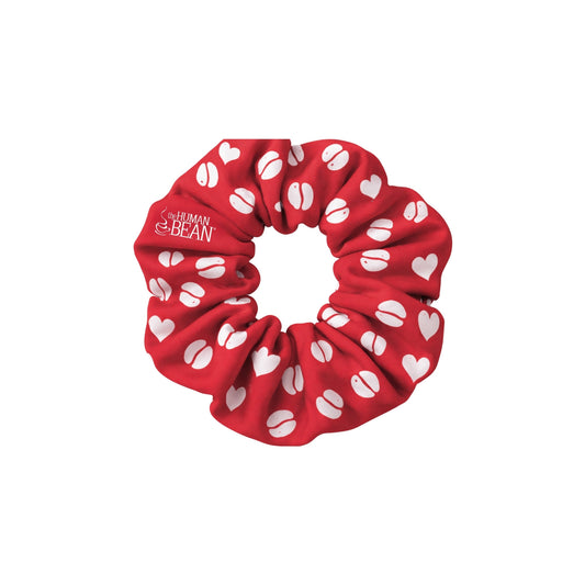Red scrunchie with white heart and coffee bean patterns on a white background